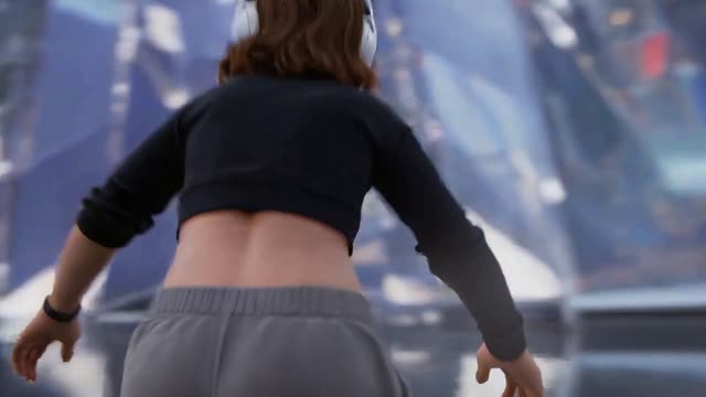 The camera maintains a sense of distance from the girl, tracking...